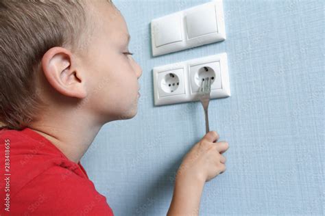 boy sticking fork into electrical box|electrical fork in outlet.